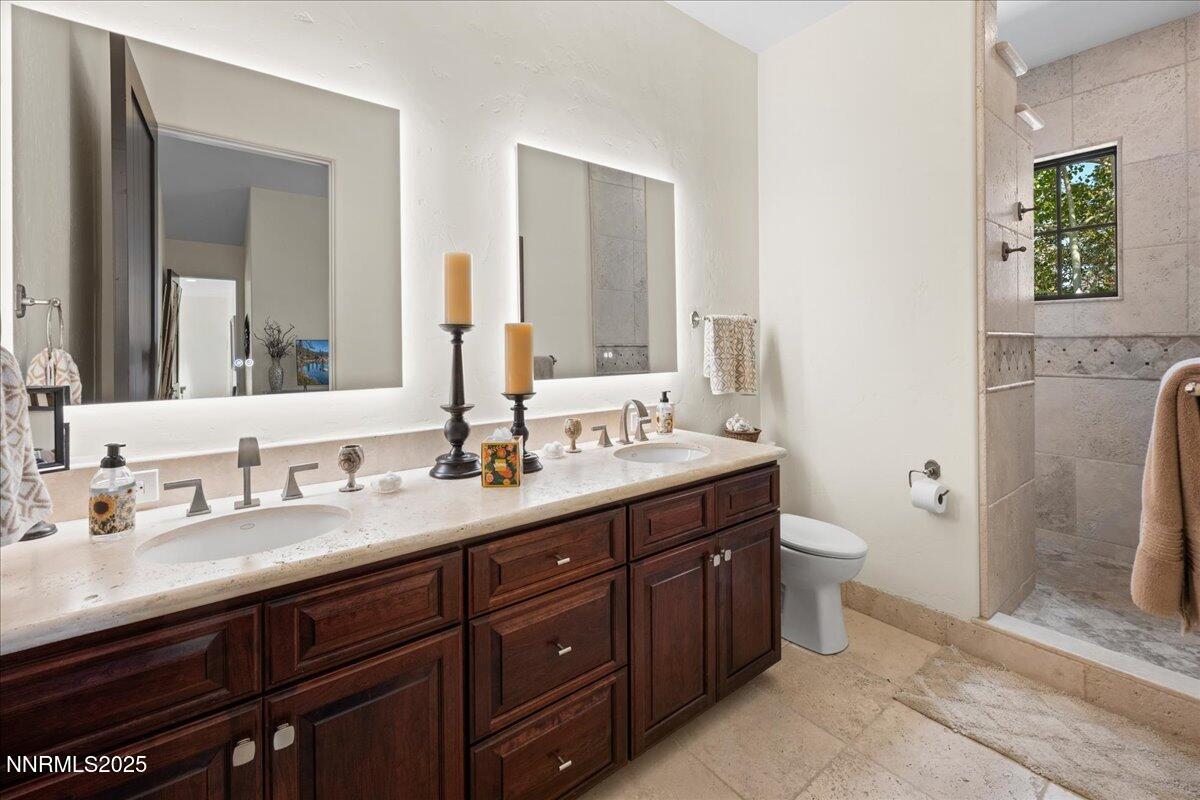 5945 Chambery Circle Reno, NV 89511 - Photo 26 of 62 a bathroom with a double vanity sink toilet and mirror