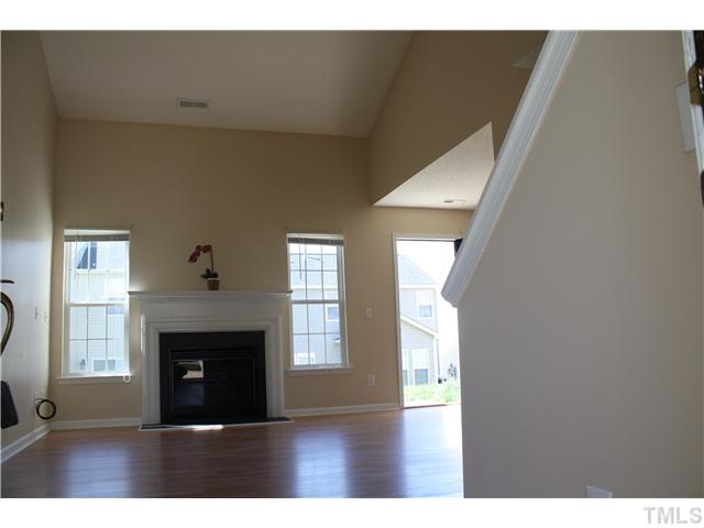 4407 Snowcrest Lane Raleigh, NC 27616 - Photo 2 of 8 a living room with a fireplace and a window