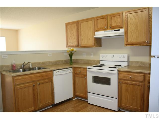 4407 Snowcrest Lane Raleigh, NC 27616 - Photo 5 of 8 a kitchen with a sink a stove and cabinets
