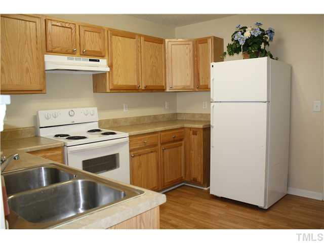 4407 Snowcrest Lane Raleigh, NC 27616 - Photo 6 of 8 a kitchen with a refrigerator sink and cabinets