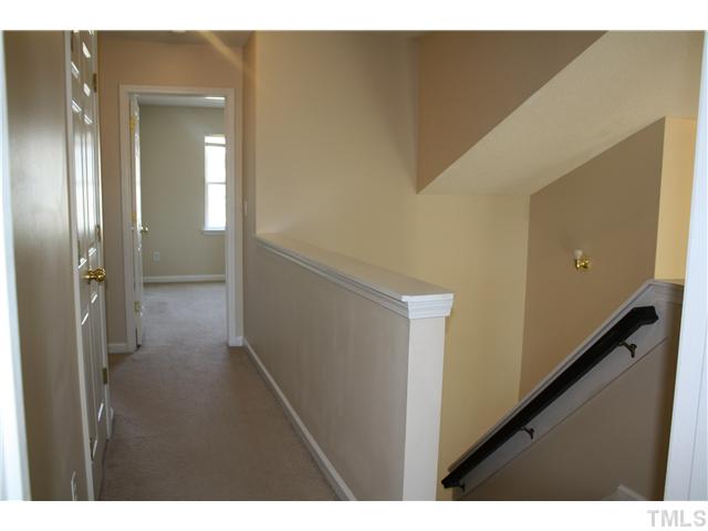 4407 Snowcrest Lane Raleigh, NC 27616 - Photo 8 of 8 a view of a hallway with wooden floor