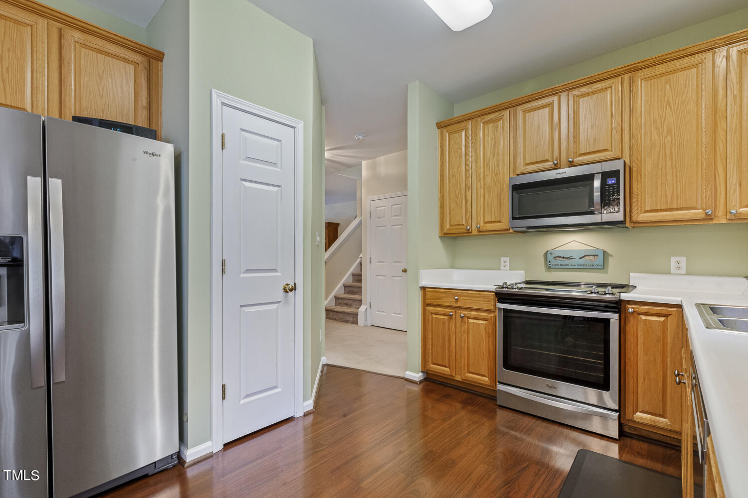 1001 Lake Moraine Place Raleigh, NC 27607 - Photo 11 of 37 a kitchen with stainless steel appliances granite countertop a refrigerator stove and microwave