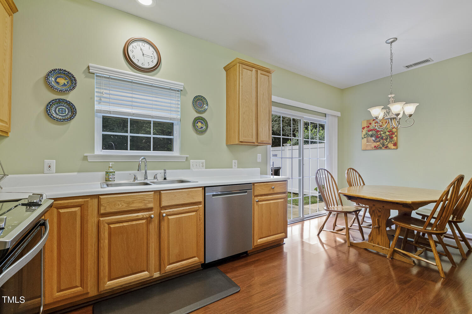 1001 Lake Moraine Place Raleigh, NC 27607 - Photo 12 of 37 a view of a kitchen area with furniture and wooden floor