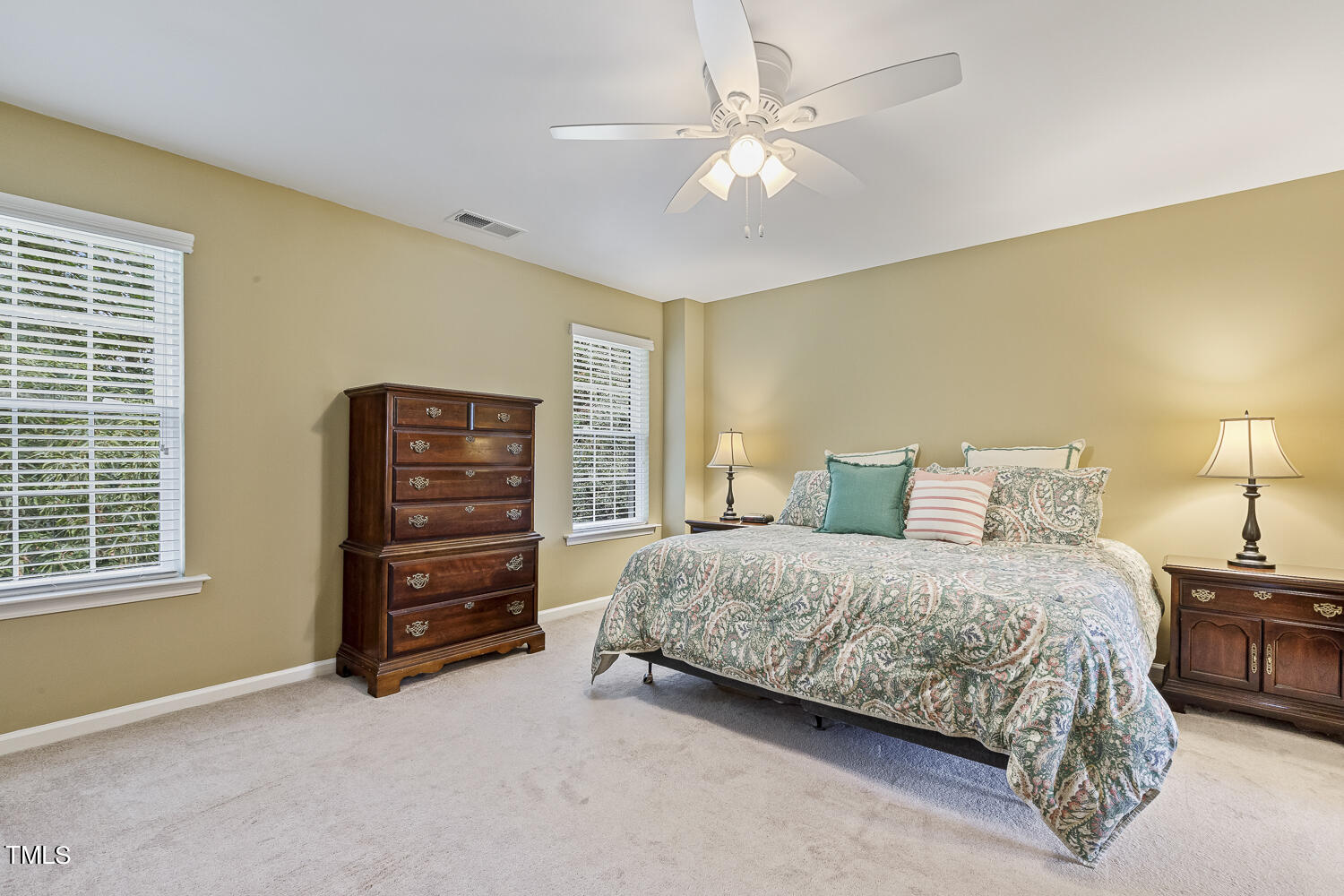 1001 Lake Moraine Place Raleigh, NC 27607 - Photo 22 of 37 a bedroom with a bed and a chandelier