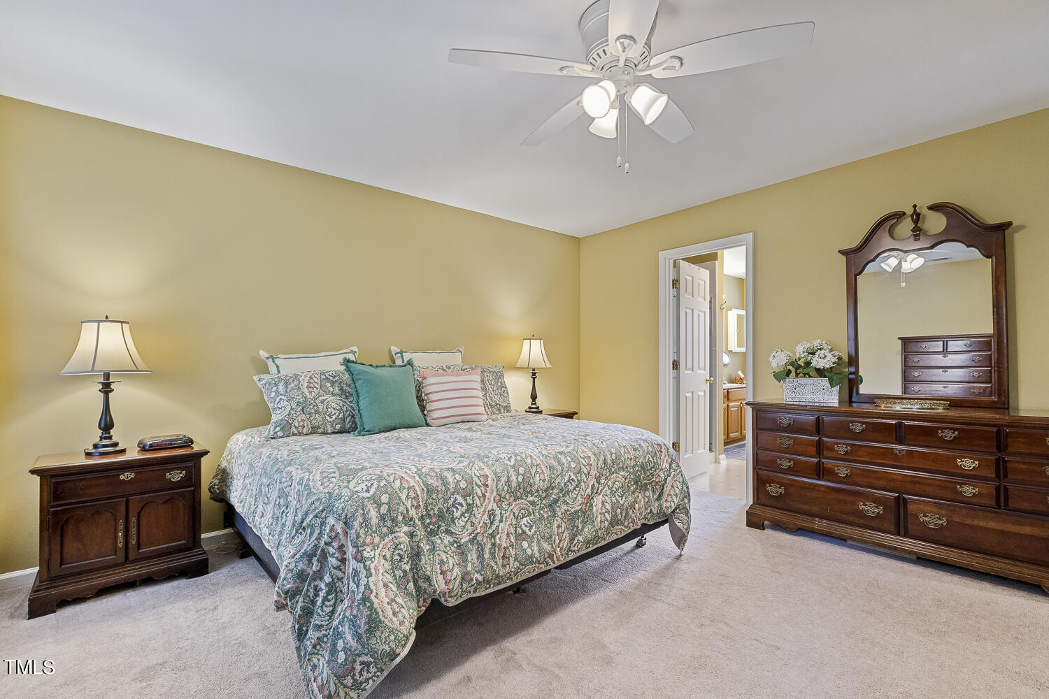 1001 Lake Moraine Place Raleigh, NC 27607 - Photo 23 of 37 a bedroom with a bed and a chandelier