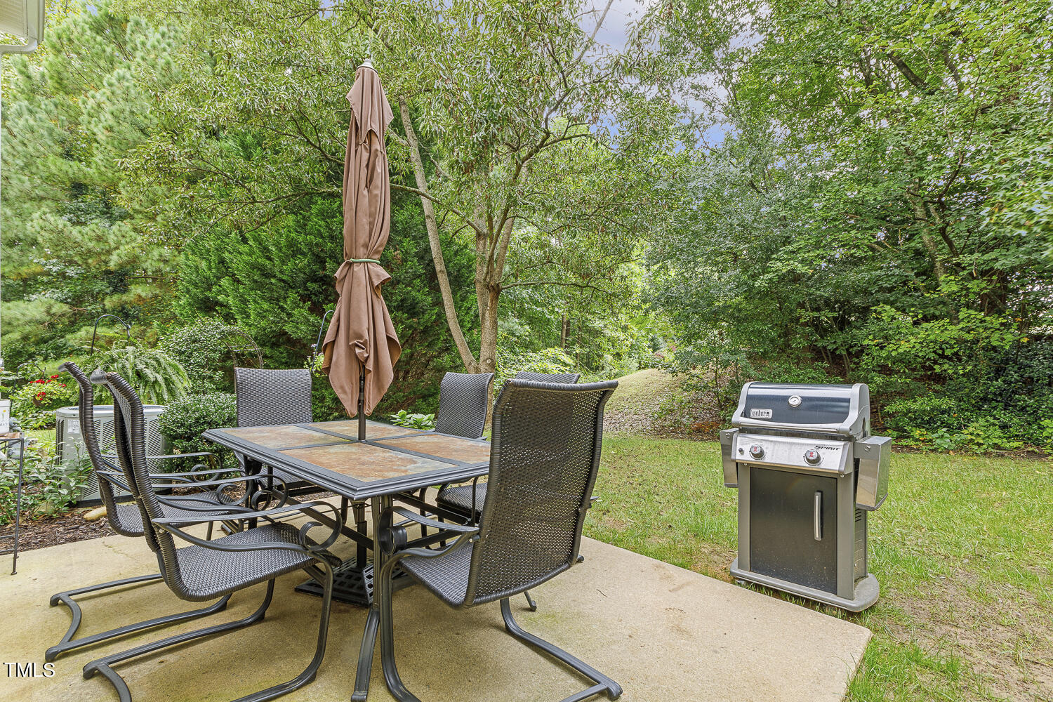 1001 Lake Moraine Place Raleigh, NC 27607 - Photo 35 of 37 a view of a chairs and table in patio with a backyard