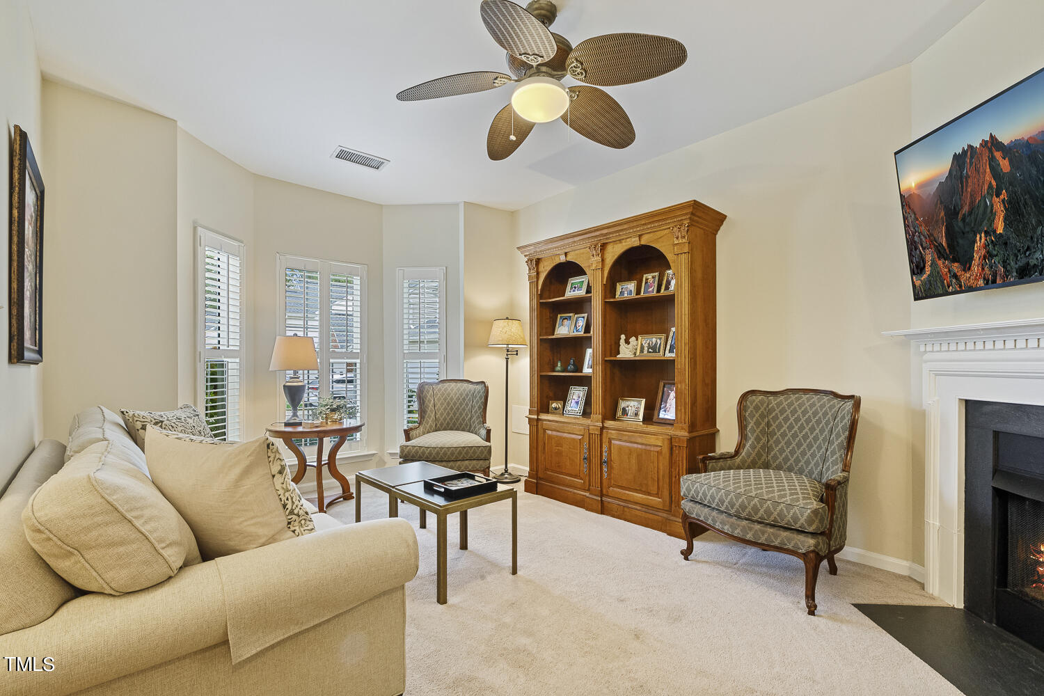 1001 Lake Moraine Place Raleigh, NC 27607 - Photo 6 of 37 a living room with furniture ceiling fan and a window