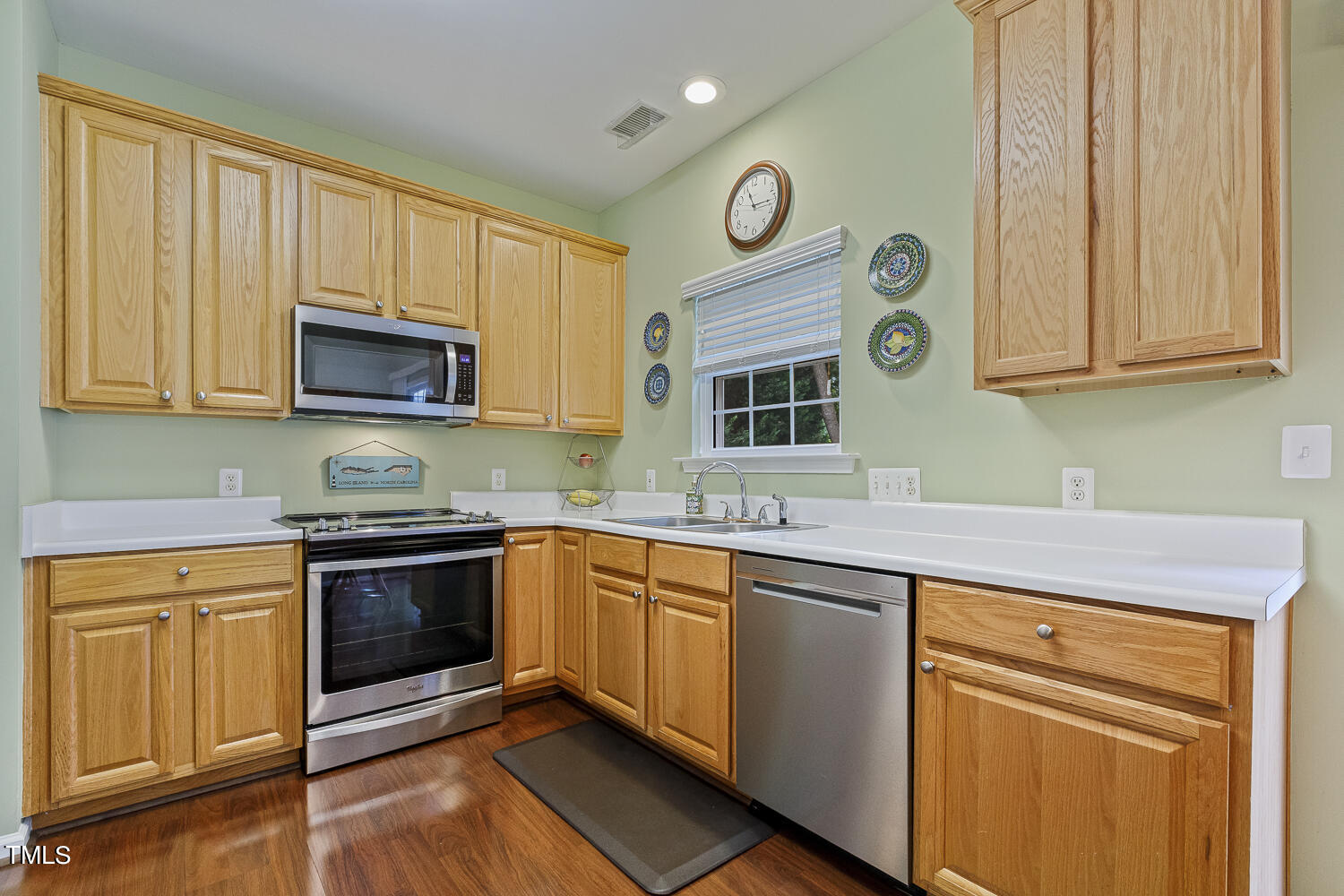 1001 Lake Moraine Place Raleigh, NC 27607 - Photo 9 of 37 a kitchen with stainless steel appliances granite countertop a stove and a microwave