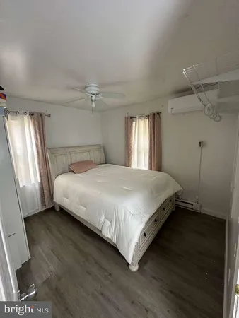 a bedroom with bed and a chandelier