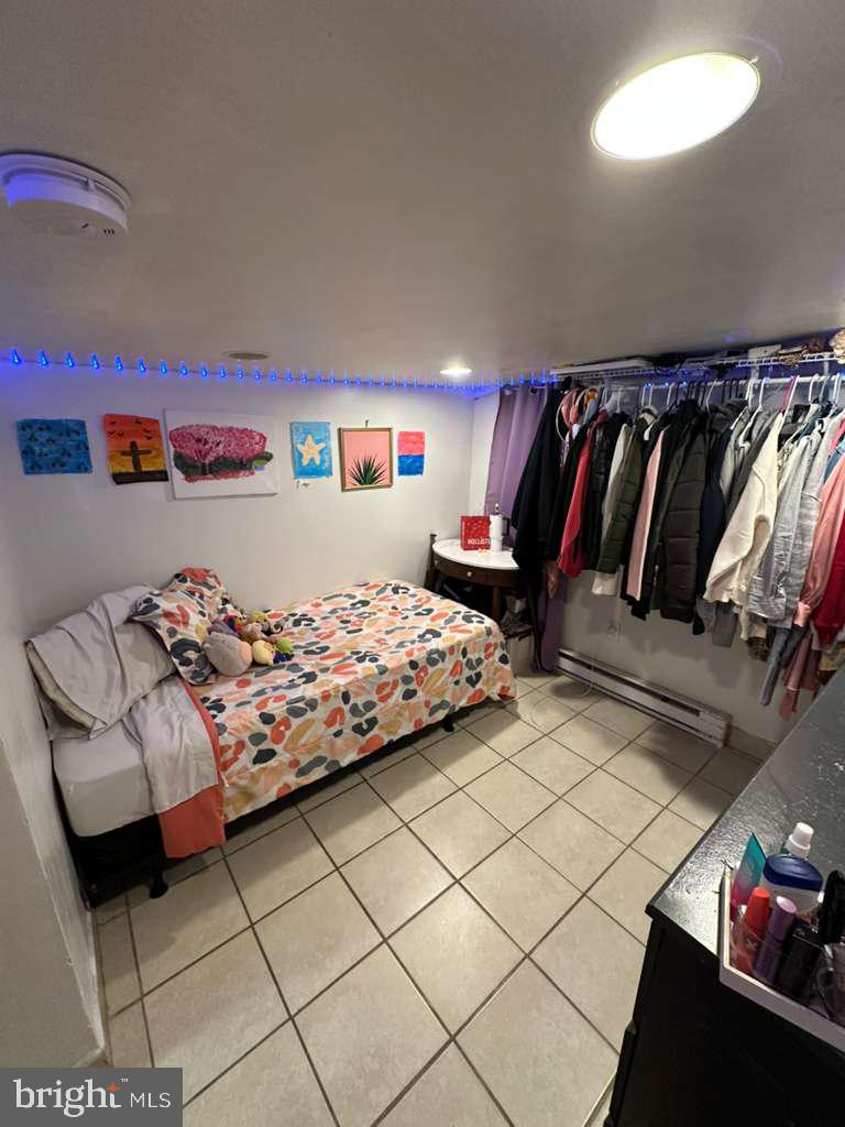 1536 Rothley Avenue Abington, PA 19090 - Photo 19 of 21 a bedroom with a bed and a lamp