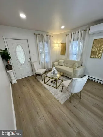 a living room with couch and a wooden floor