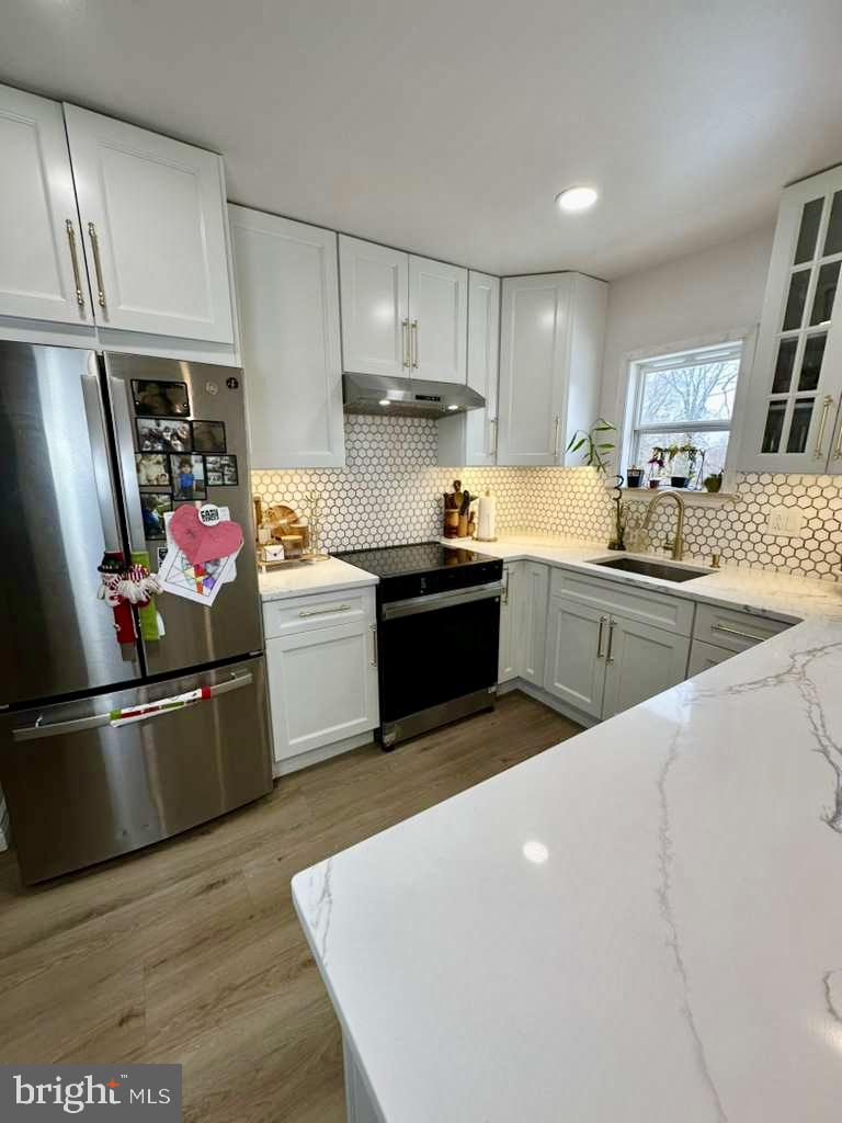 1536 Rothley Avenue Abington, PA 19090 - Photo 9 of 21 a kitchen with stainless steel appliances granite countertop a sink dishwasher stove top oven and refrigerator
