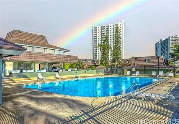 a view of a swimming pool with outdoor seating