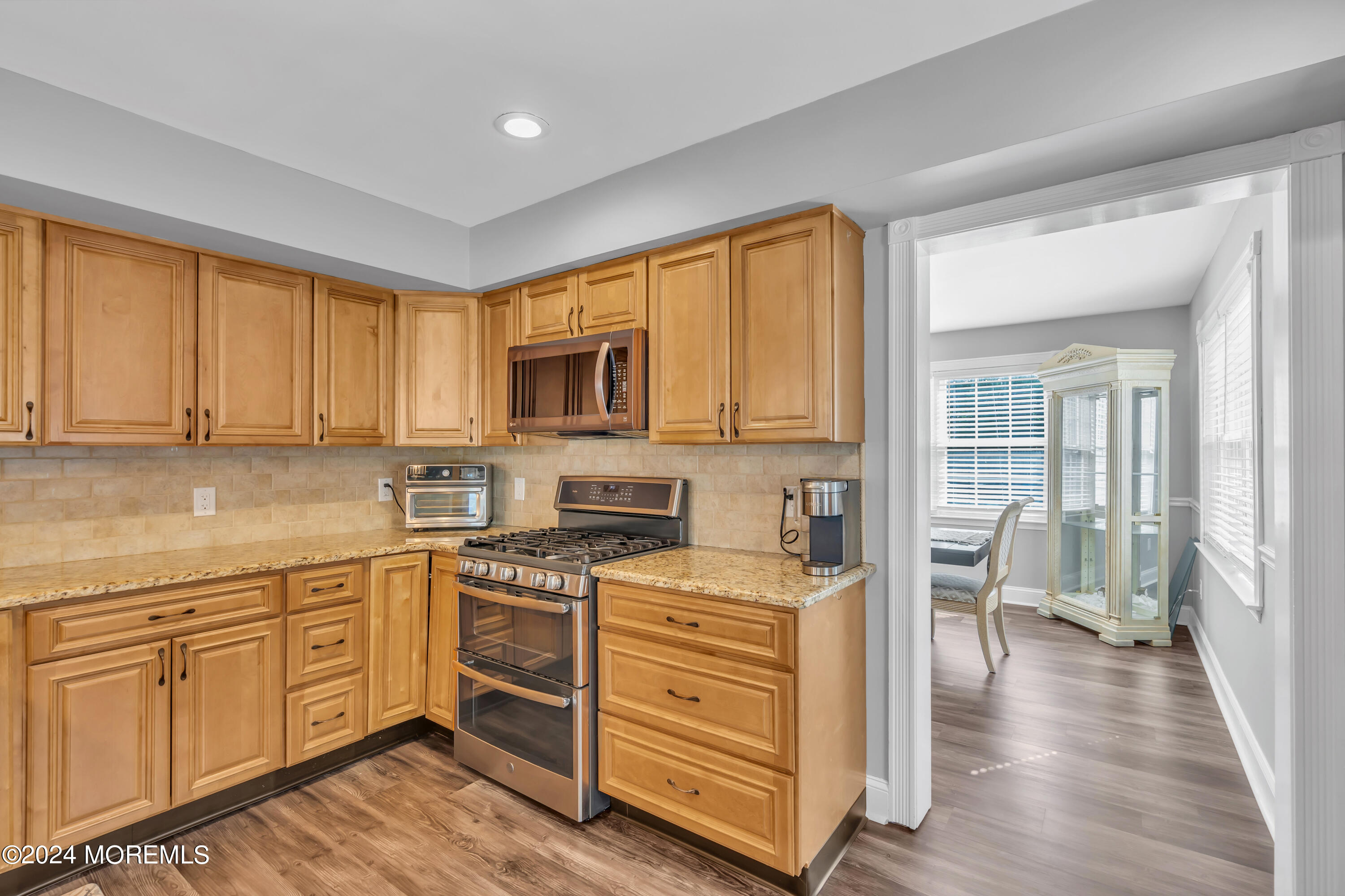 538 Adamston Road Brick, NJ 08723 - Photo 15 of 55 a kitchen with white cabinets and wooden floor