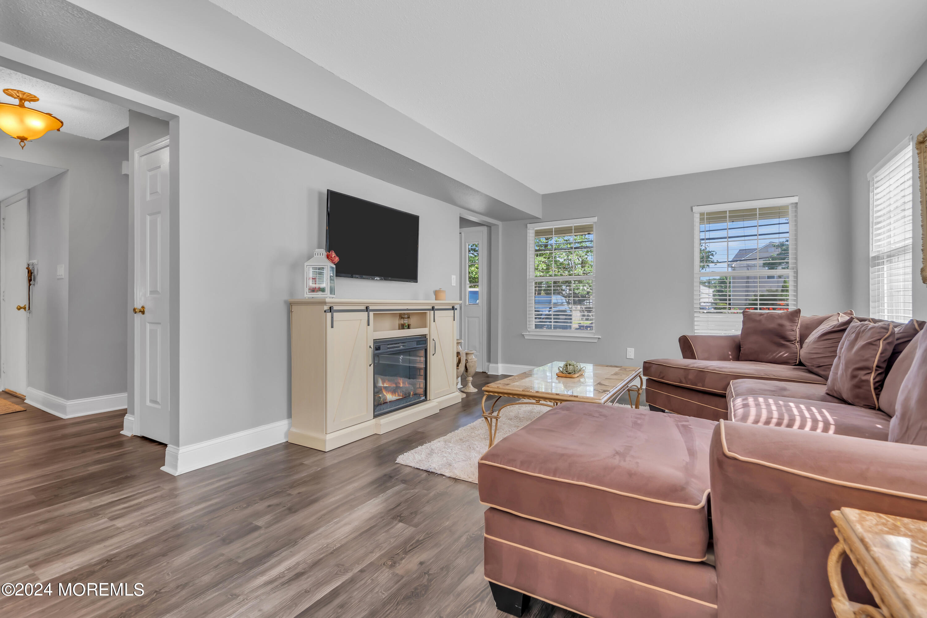 538 Adamston Road Brick, NJ 08723 - Photo 9 of 55 a living room with furniture a flat screen tv and a fireplace