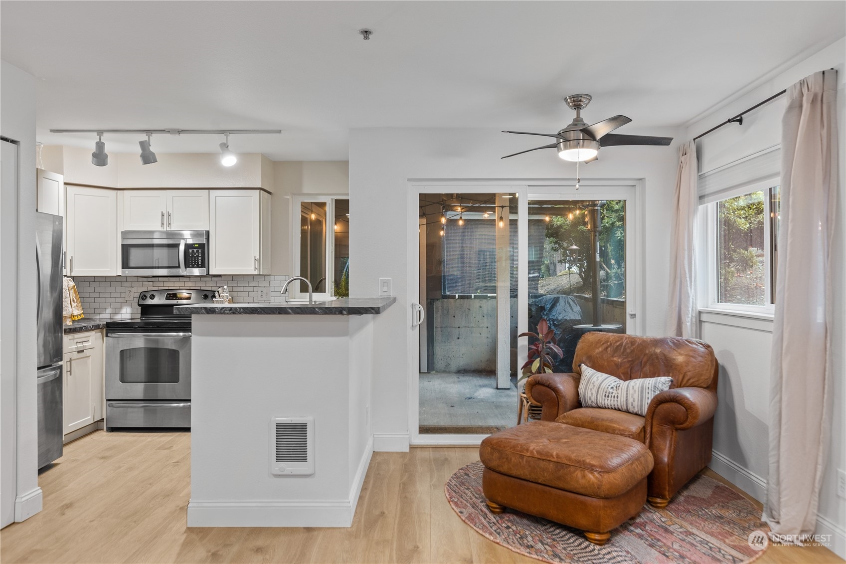 3921 243rd Place Southeast, Unit J104 Bothell, WA 98021 - Photo 8 of 40 a living room with stainless steel appliances furniture and a kitchen view