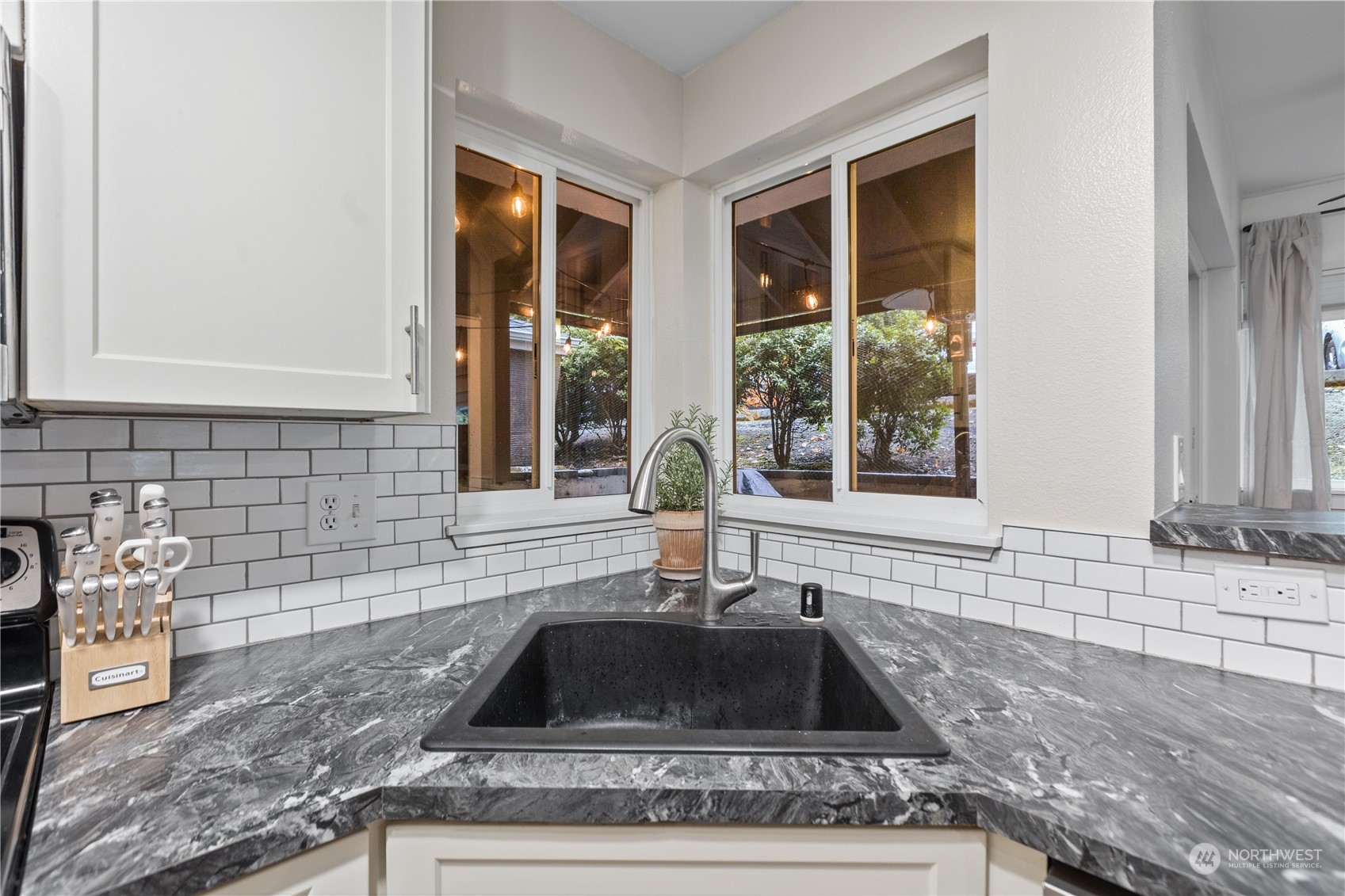 3921 243rd Place Southeast, Unit J104 Bothell, WA 98021 - Photo 10 of 40 a kitchen with granite countertop a sink and a window