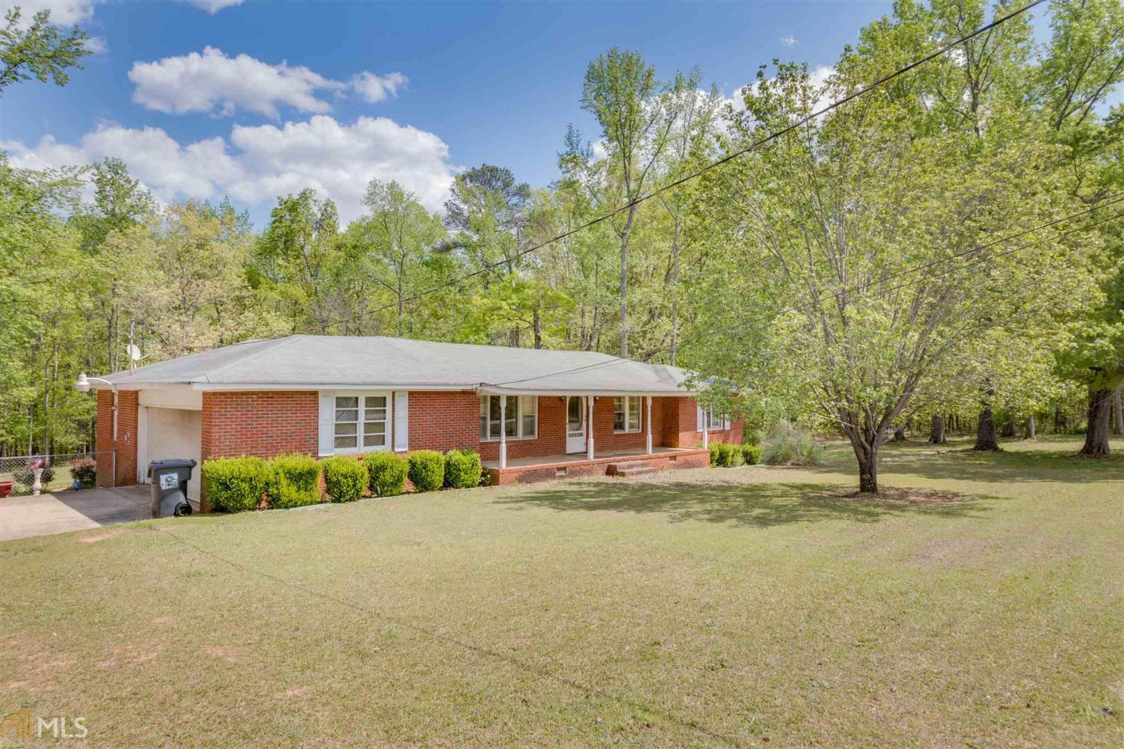 168 Sandy Ridge Road McDonough, GA 30252 - Photo 1 of 1 a front view of a house with a yard and trees