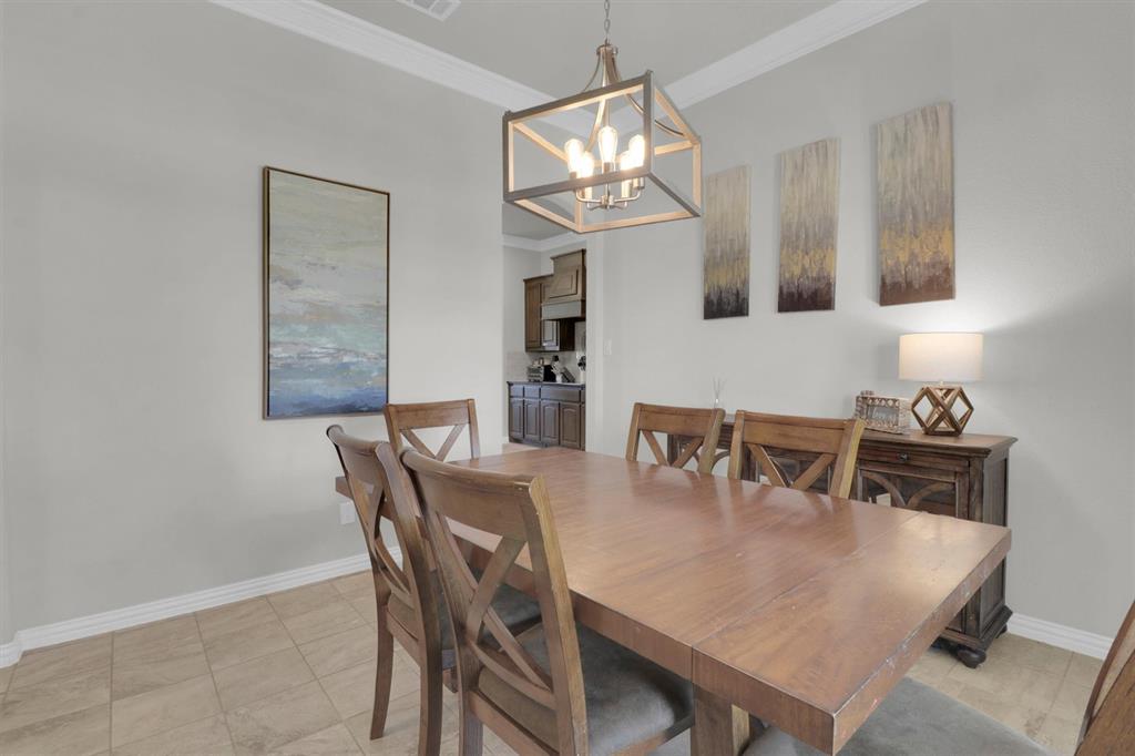 7818 Sagebrush Lane Godley, TX 76044 - Photo 11 of 38 a view of a dining room with furniture and a chandelier