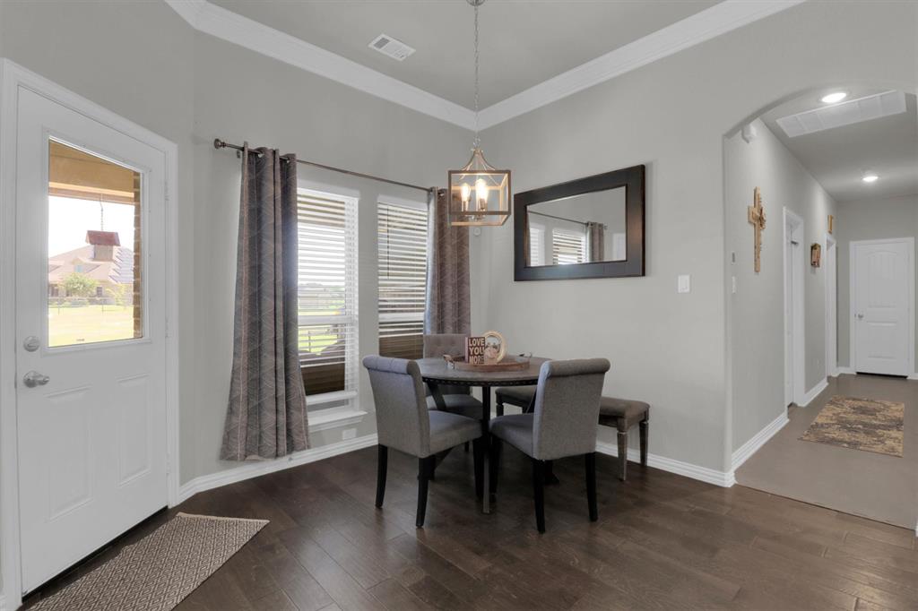 7818 Sagebrush Lane Godley, TX 76044 - Photo 14 of 38 a view of a dining room with furniture and wooden floor