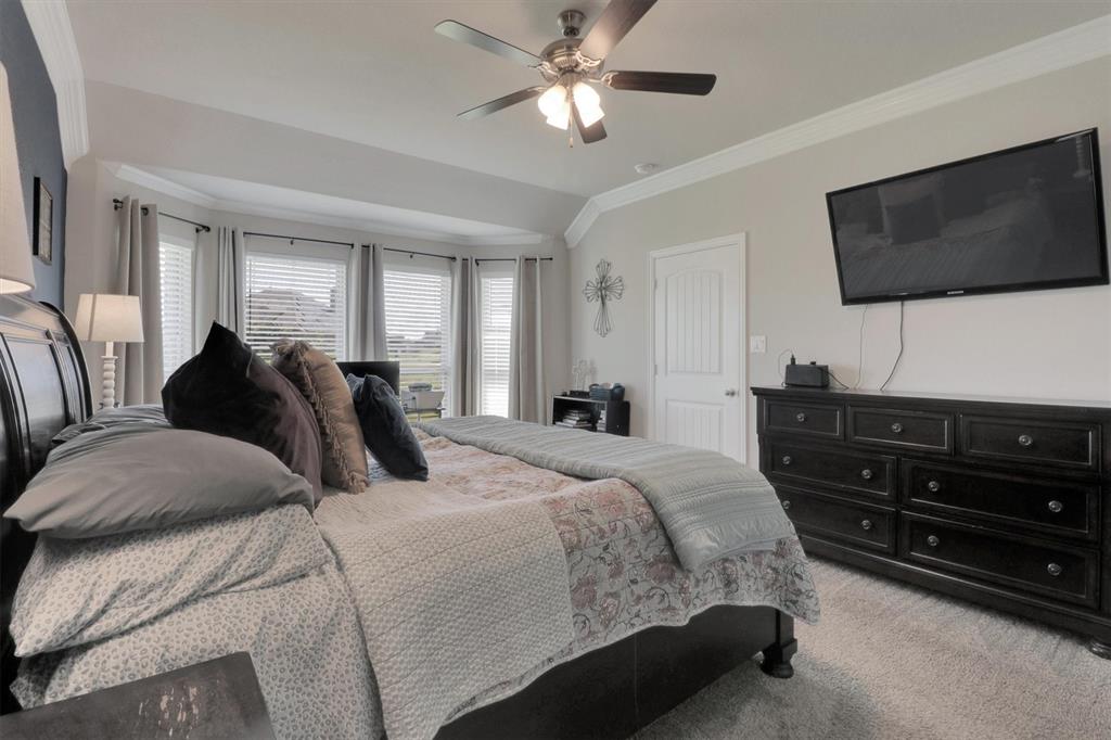7818 Sagebrush Lane Godley, TX 76044 - Photo 15 of 38 a bedroom with a bed and a flat screen tv