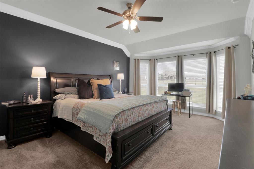 7818 Sagebrush Lane Godley, TX 76044 - Photo 16 of 38 a bed room with a bed and a chandelier