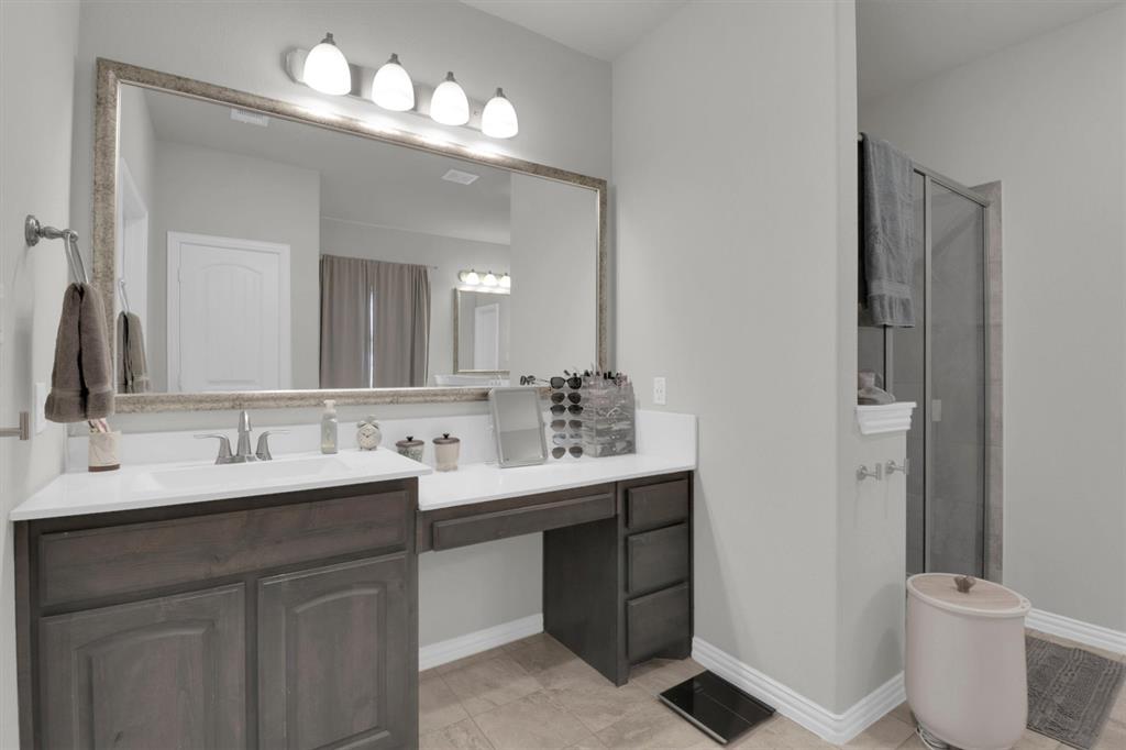 7818 Sagebrush Lane Godley, TX 76044 - Photo 19 of 38 a bathroom with a toilet a sink and mirror