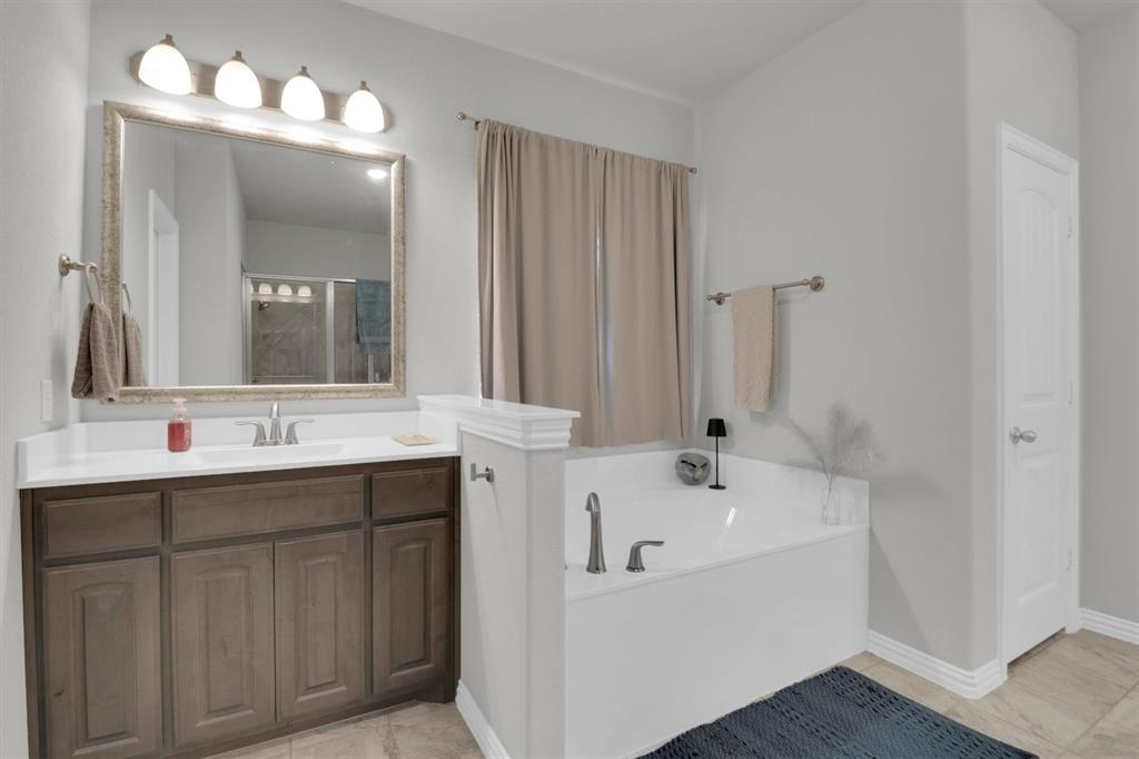 7818 Sagebrush Lane Godley, TX 76044 - Photo 20 of 38 a bathroom with a sink and a mirror