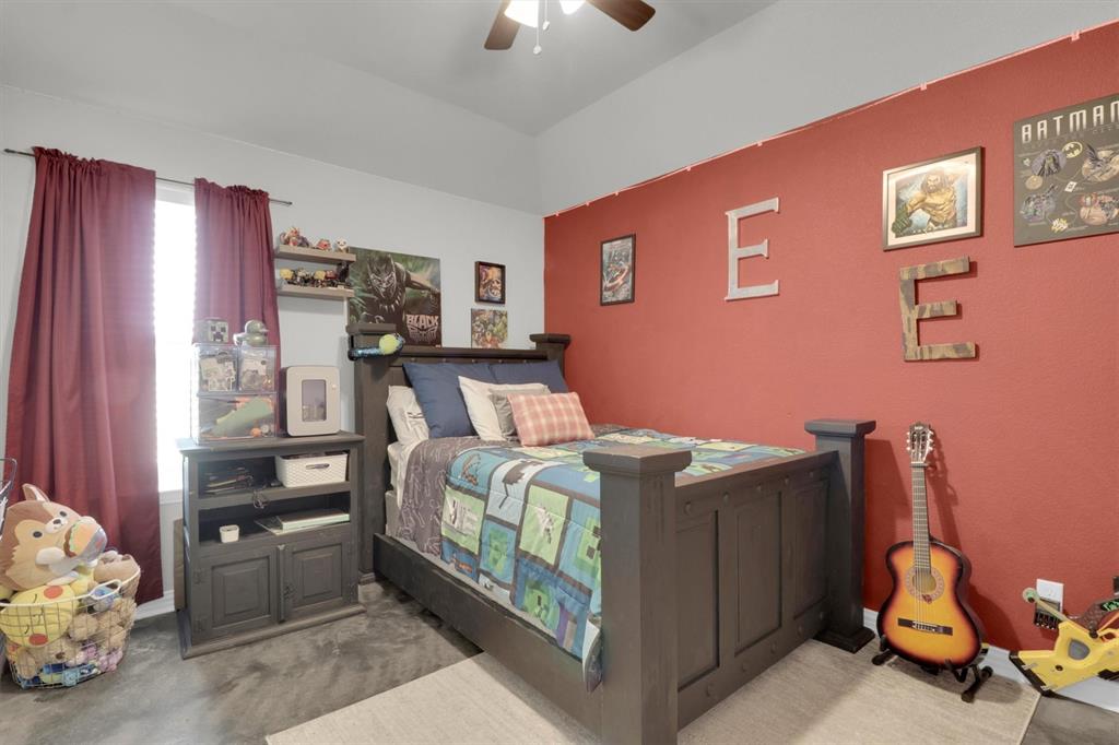 7818 Sagebrush Lane Godley, TX 76044 - Photo 23 of 38 a bed room with a bed and a chandelier