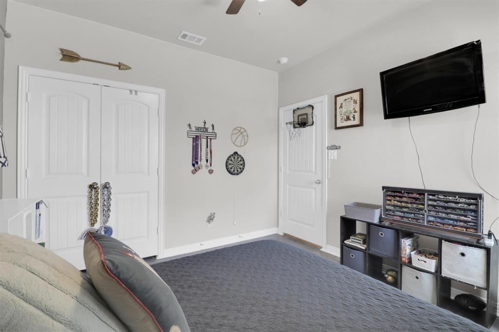 7818 Sagebrush Lane Godley, TX 76044 - Photo 26 of 38 a bedroom with a bed and a flat screen tv
