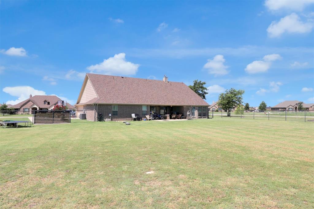 7818 Sagebrush Lane Godley, TX 76044 - Photo 36 of 38 a front view of house with yard and outdoor seating