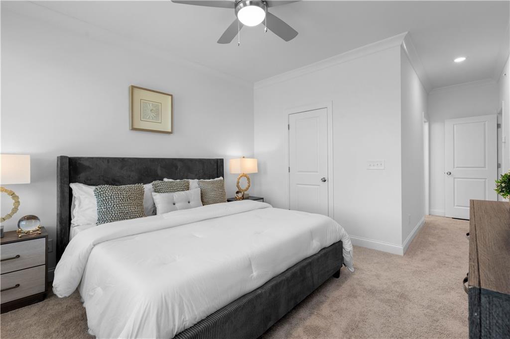 538 Alice Way, Unit D3 Cumming, GA 30040 - Photo 15 of 52 a bedroom with a bed and a chandelier