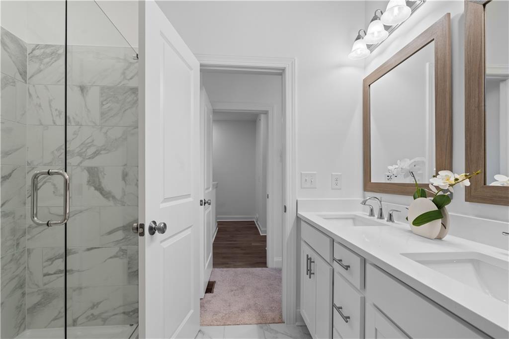 538 Alice Way, Unit D3 Cumming, GA 30040 - Photo 18 of 52 a bathroom with a double vanity sink mirror and shower