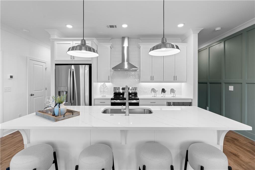 538 Alice Way, Unit D3 Cumming, GA 30040 - Photo 4 of 52 a kitchen with kitchen island a white counter top space a sink and appliances