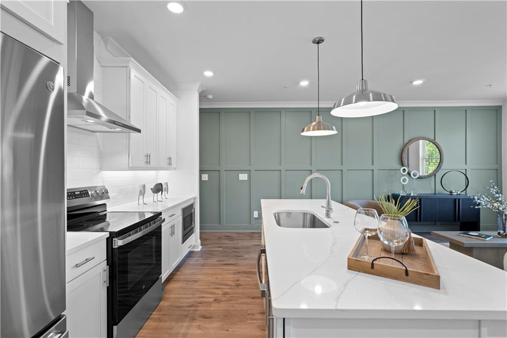 538 Alice Way, Unit D3 Cumming, GA 30040 - Photo 7 of 52 a kitchen with stainless steel appliances granite countertop a stove a sink and a refrigerator