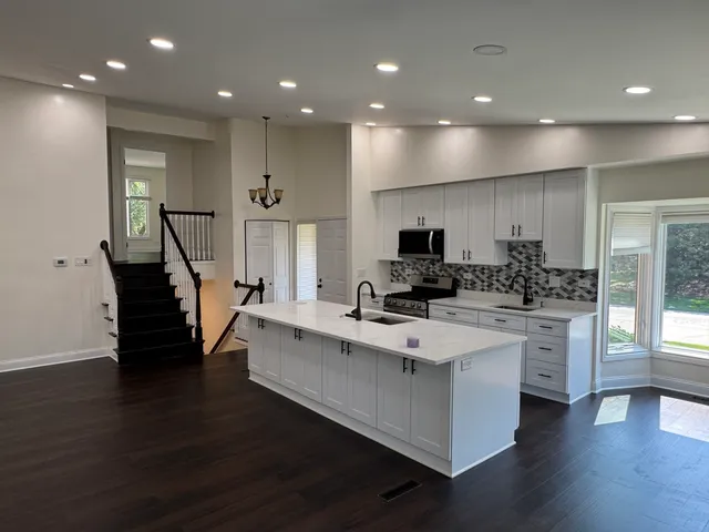 a view of kitchen with cabinets and wooden floor