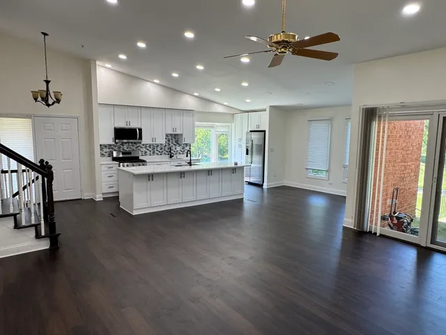 a view of a kitchen with a sink cabinets and wooden floor
