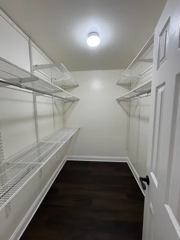 a view of storage and utility room with wooden floor