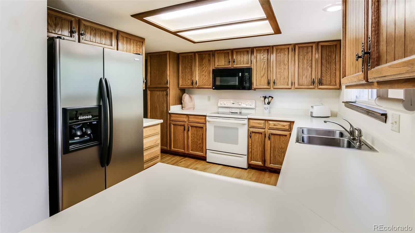 82 Prairie Ridge Road Highlands Ranch, CO 80126 - Photo 12 of 29 a kitchen with stainless steel appliances a refrigerator a sink a stove and cabinets