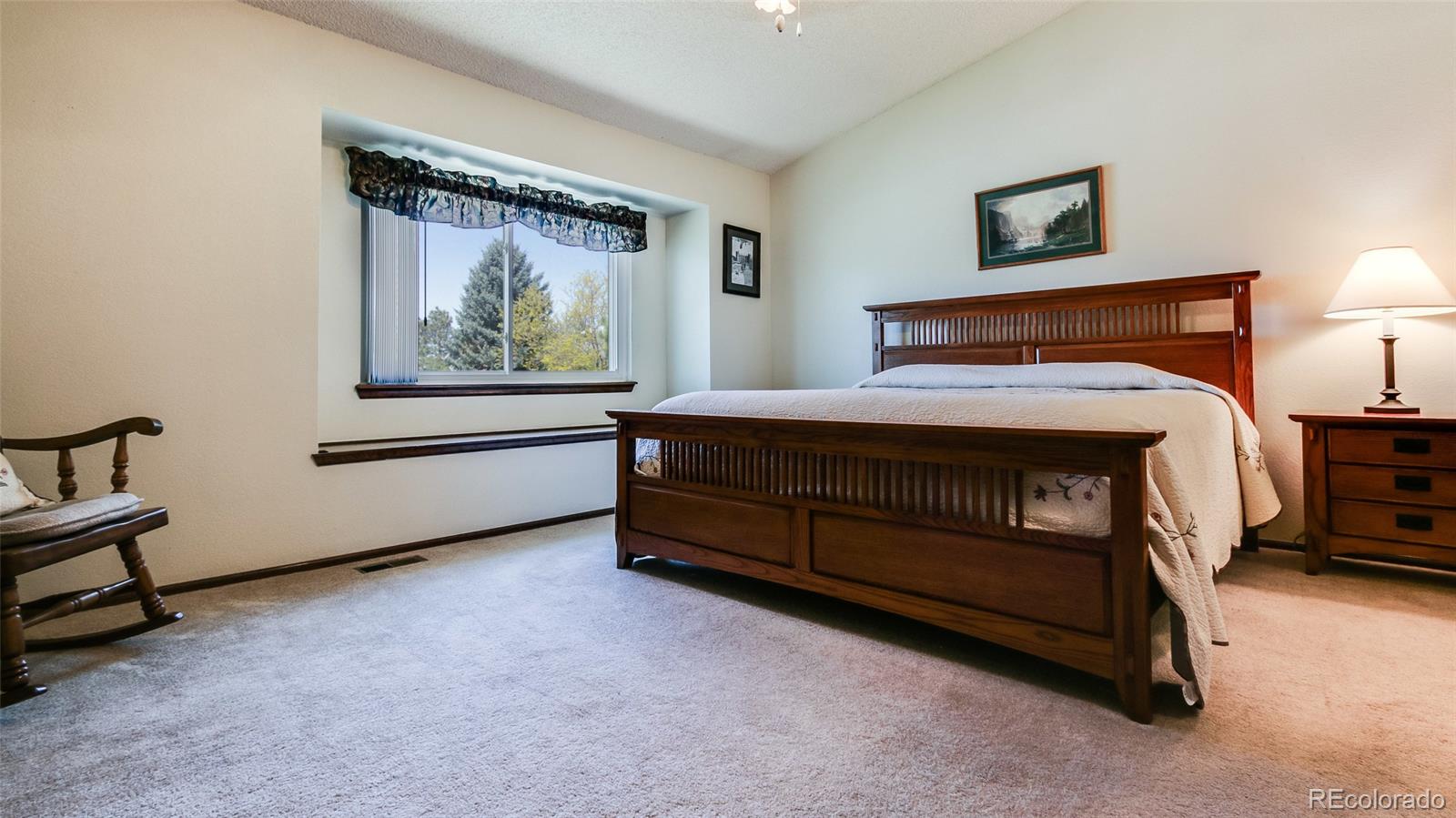 82 Prairie Ridge Road Highlands Ranch, CO 80126 - Photo 16 of 29 a bedroom with a bed and a painting on the wall