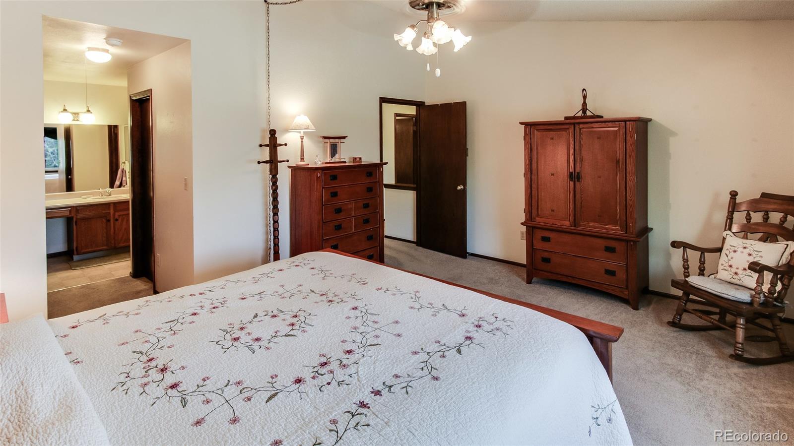 82 Prairie Ridge Road Highlands Ranch, CO 80126 - Photo 17 of 29 a bedroom with a bed and a dresser in it