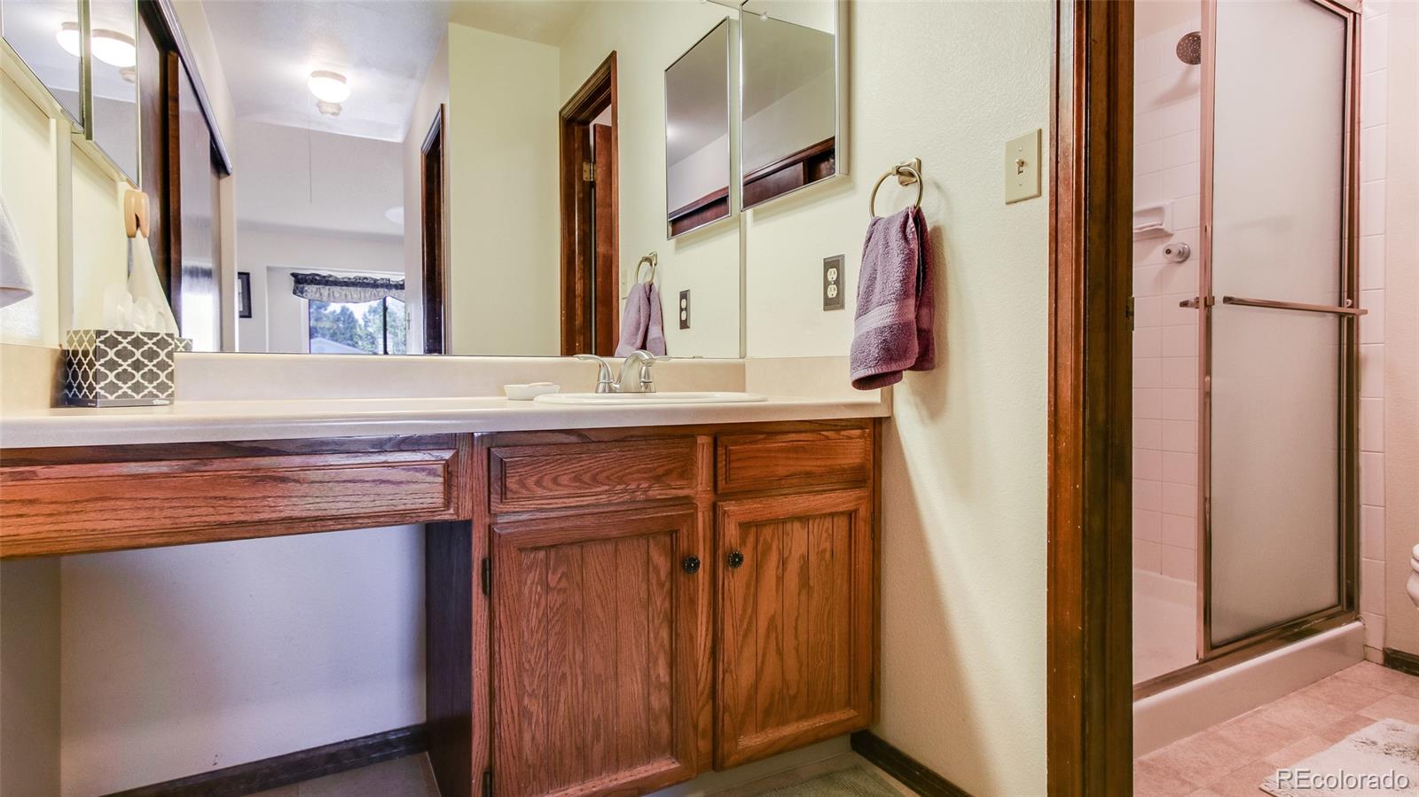 82 Prairie Ridge Road Highlands Ranch, CO 80126 - Photo 18 of 29 a view of a hallway with a cabinet and a mirror