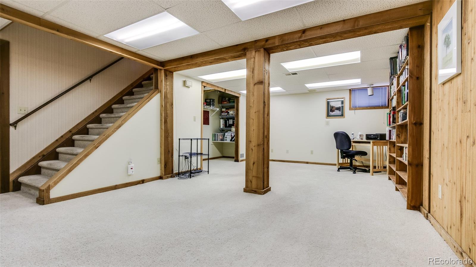 82 Prairie Ridge Road Highlands Ranch, CO 80126 - Photo 22 of 29 a view of an empty room with wooden floor and furniture