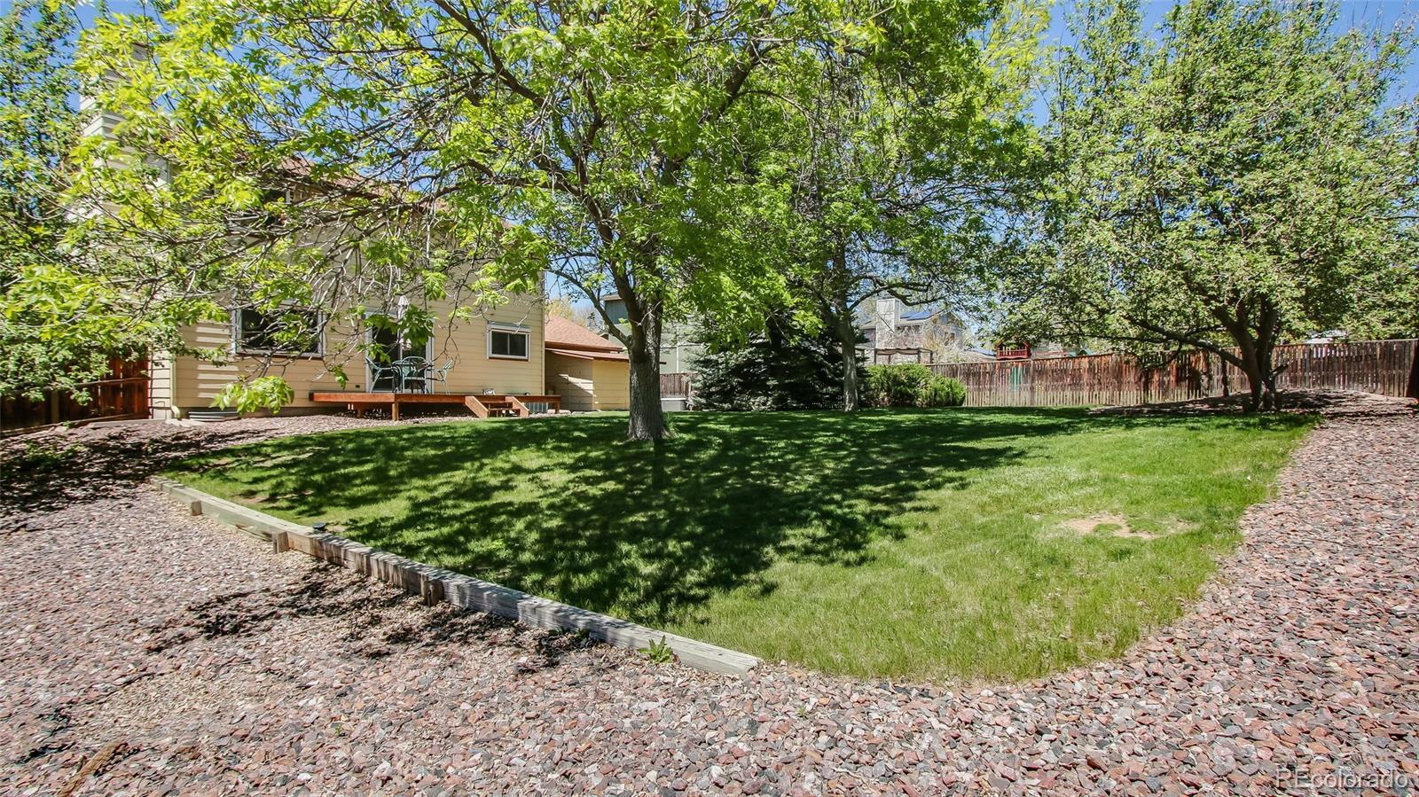 82 Prairie Ridge Road Highlands Ranch, CO 80126 - Photo 29 of 29 a front view of a house with a yard and trees