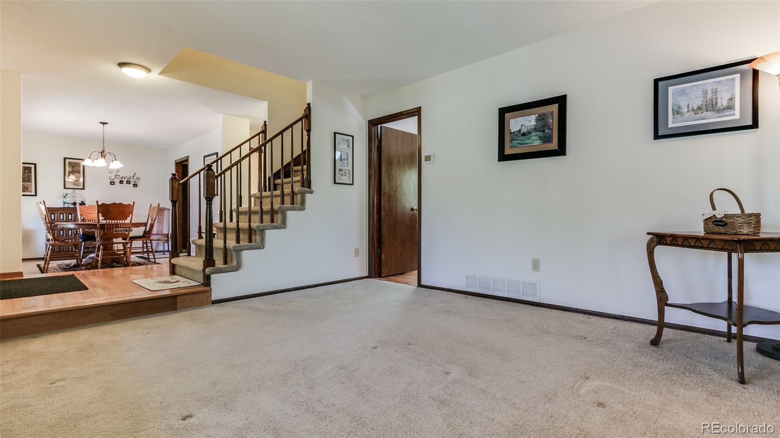 82 Prairie Ridge Road Highlands Ranch, CO 80126 - Photo 3 of 29 a view of a hallway with a livingroom and entryway
