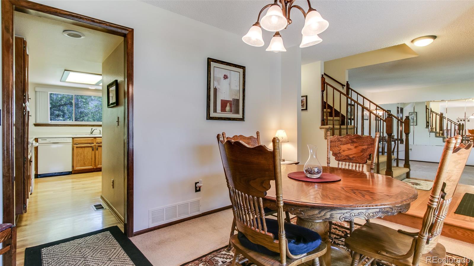 82 Prairie Ridge Road Highlands Ranch, CO 80126 - Photo 7 of 29 a view of a dining room with furniture and a chandelier