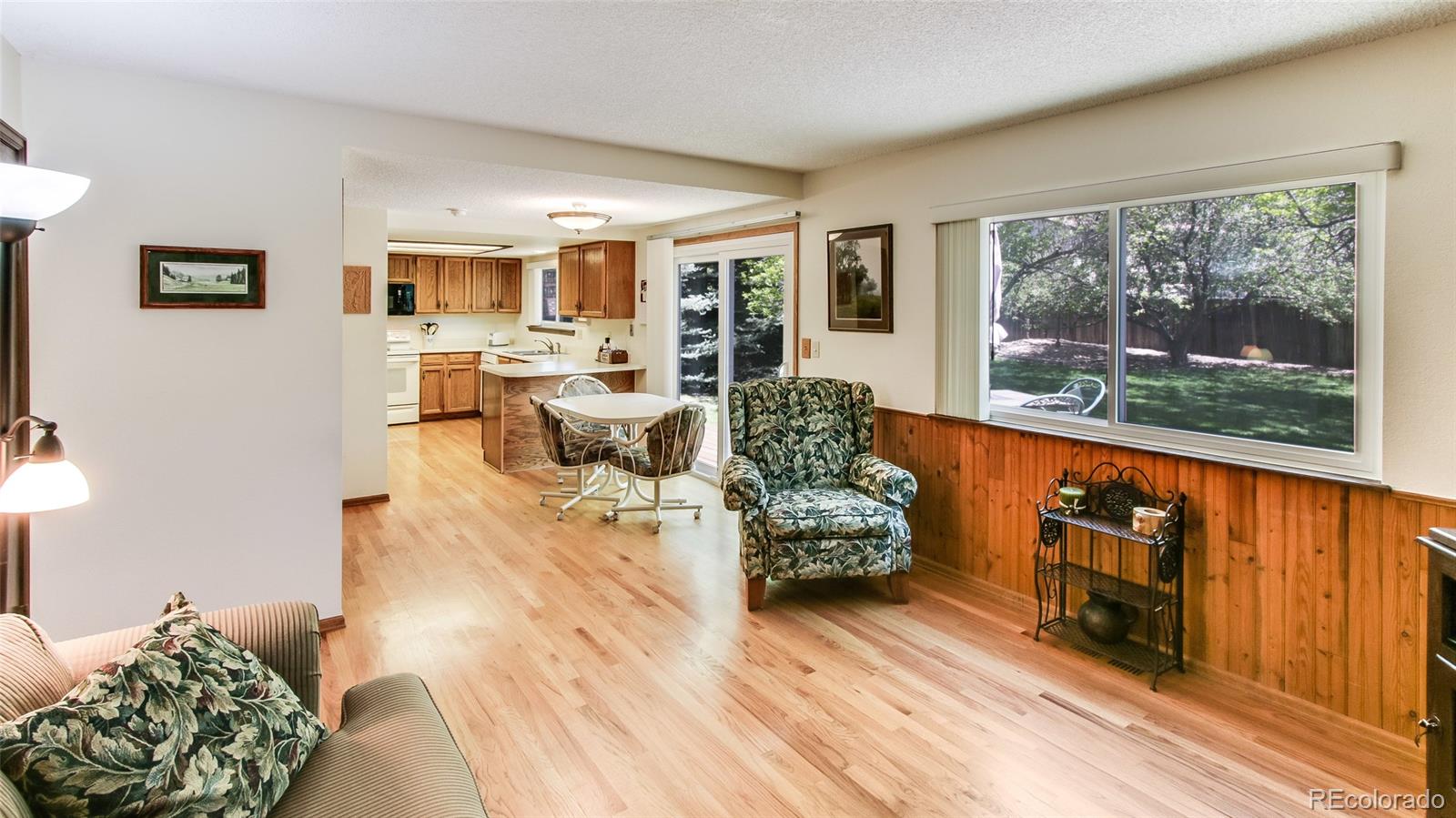 82 Prairie Ridge Road Highlands Ranch, CO 80126 - Photo 10 of 29 a living room with furniture and a floor to ceiling window