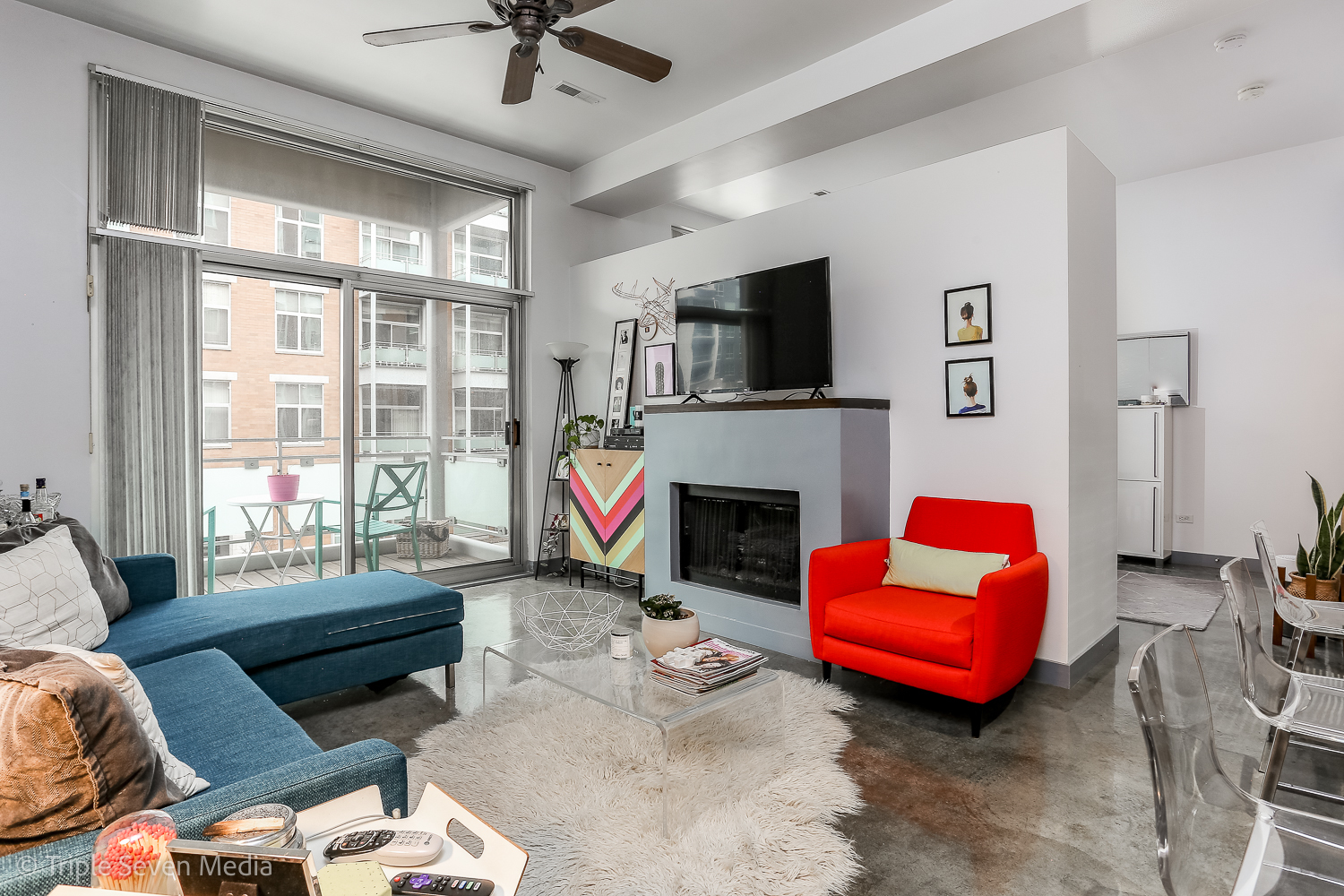 939 West Madison Street, Unit 206 Chicago, IL 60607 - Photo 2 of 20 a living room with furniture a fireplace and a flat screen tv