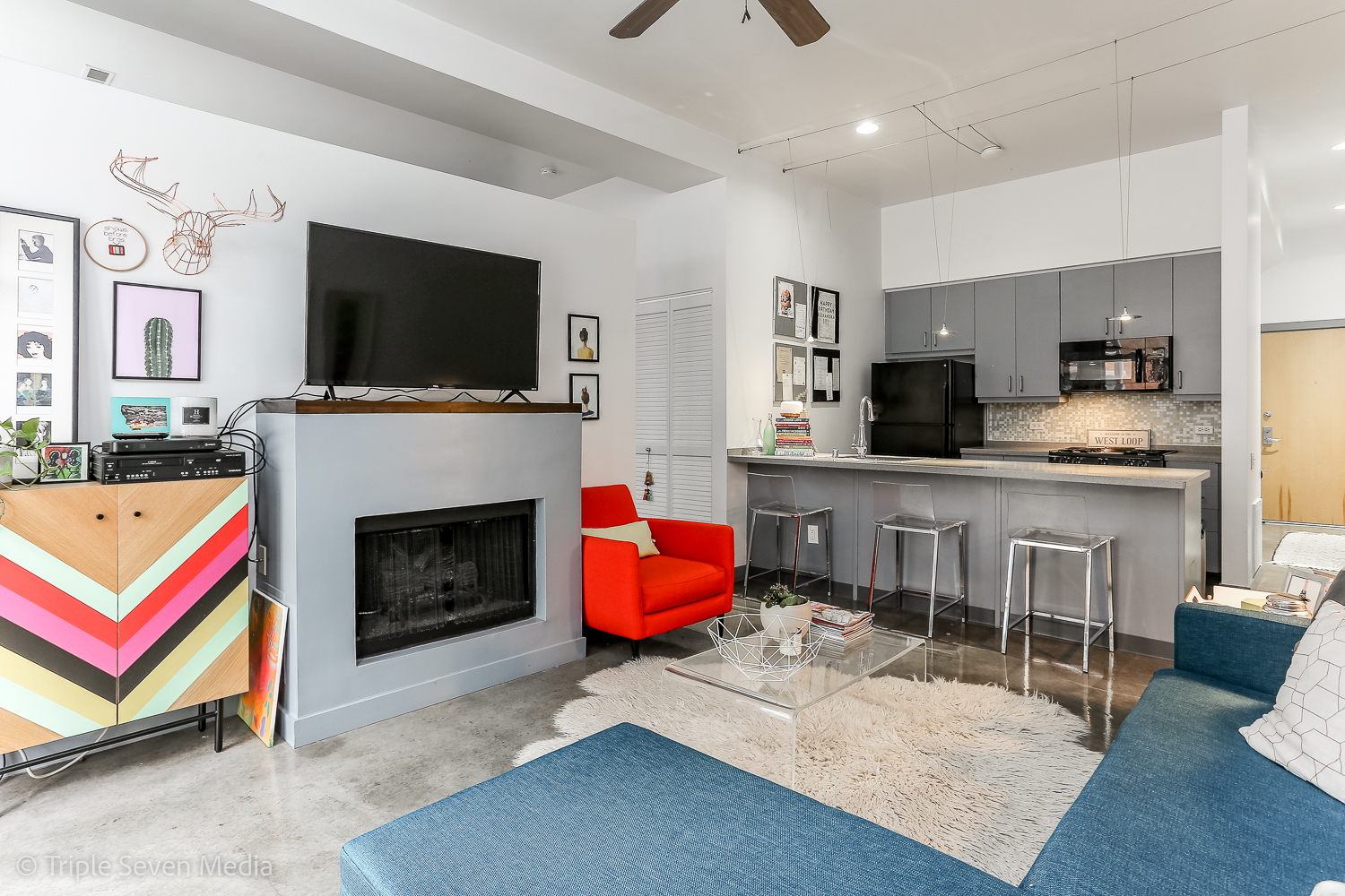 939 West Madison Street, Unit 206 Chicago, IL 60607 - Photo 5 of 20 a living room with furniture a flat screen tv and a fireplace