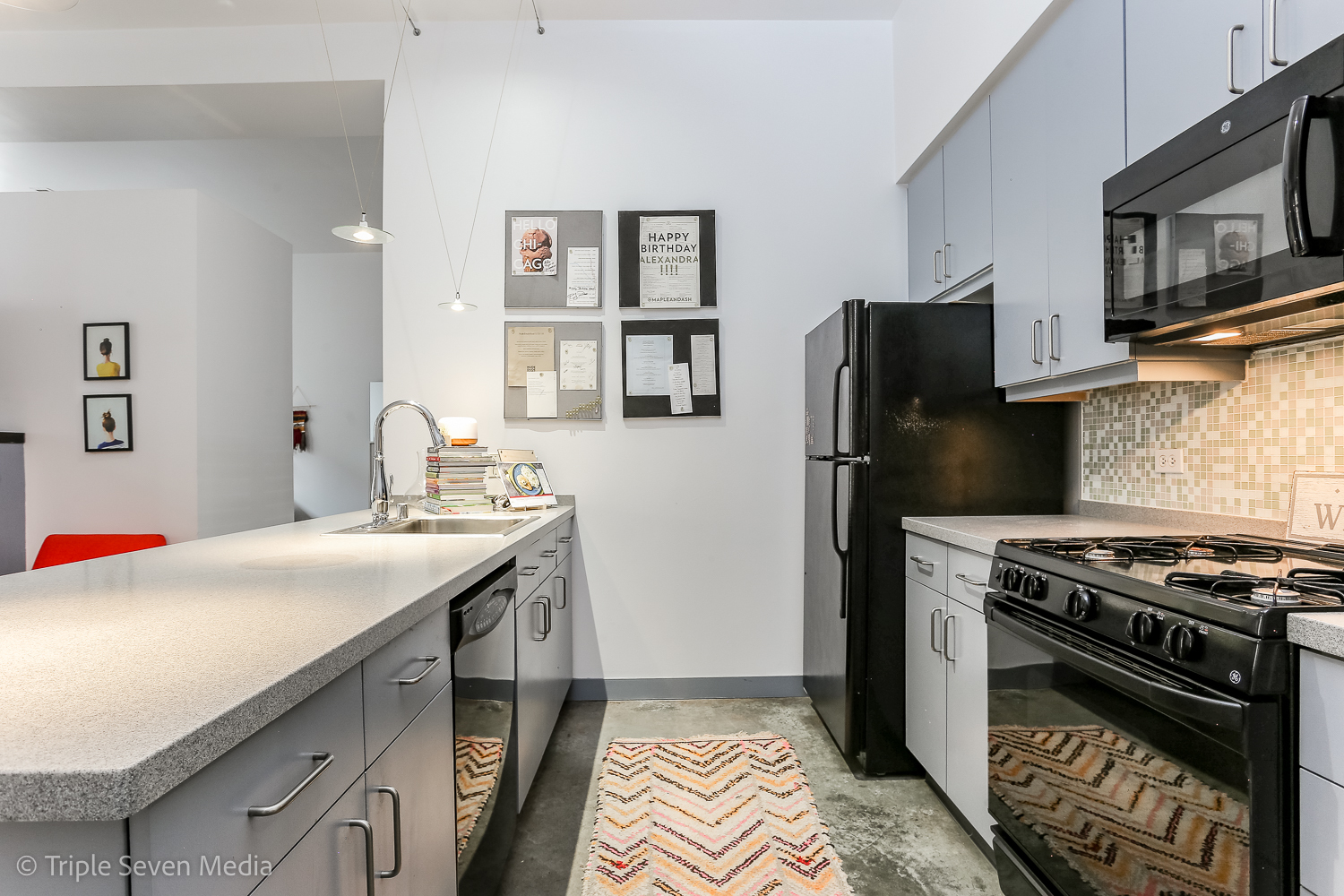 939 West Madison Street, Unit 206 Chicago, IL 60607 - Photo 8 of 20 a kitchen with stainless steel appliances a stove a sink and a refrigerator